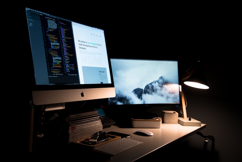 Web development workspace with multiple screens showing code and design